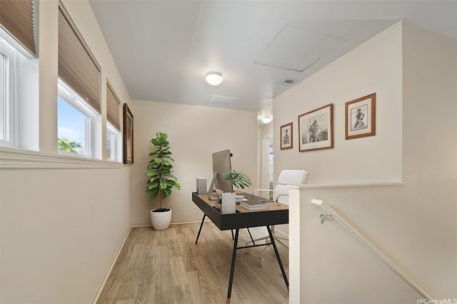 home office featuring baseboards, visible vents, and light wood finished floors