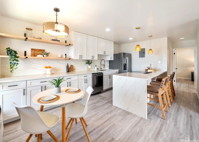 kitchen with high end refrigerator, a kitchen breakfast bar, decorative backsplash, and dishwasher