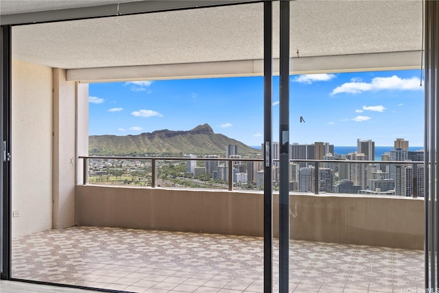 interior space featuring tile patterned floors, a city view, and a mountain view