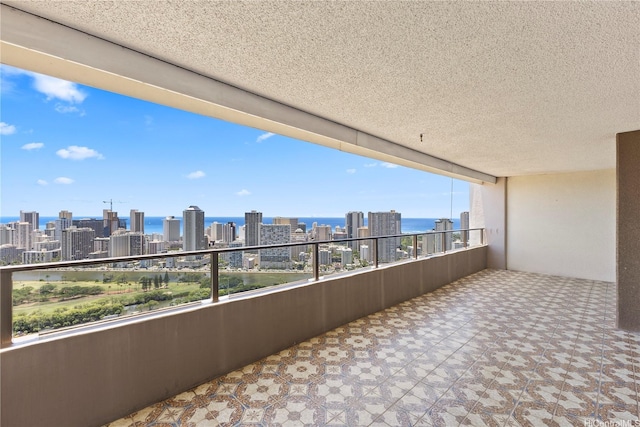 balcony featuring a city view and a water view