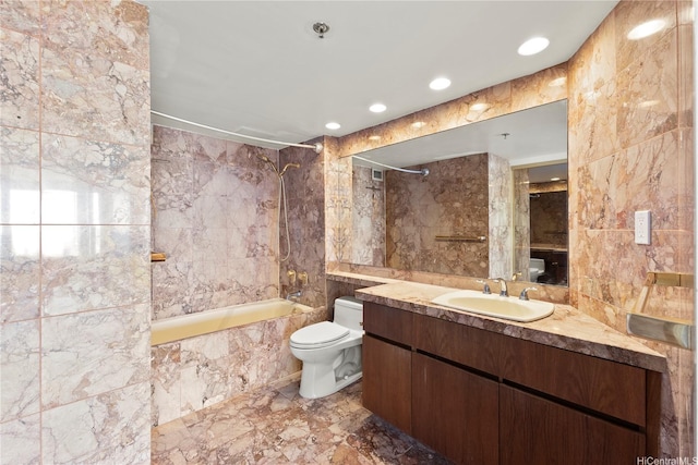 bathroom with vanity, shower / bathtub combination, toilet, marble finish floor, and tile walls