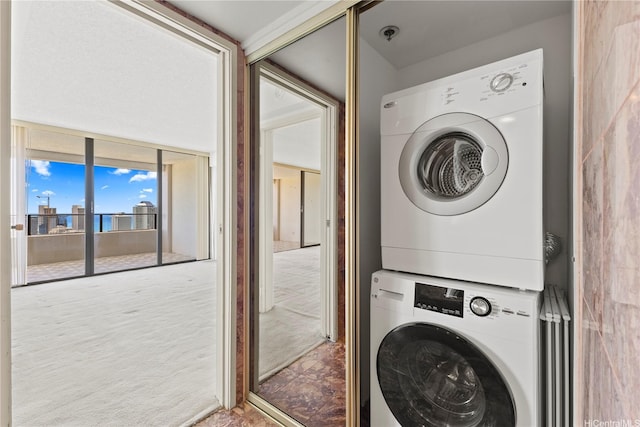 laundry area featuring stacked washing maching and dryer and laundry area