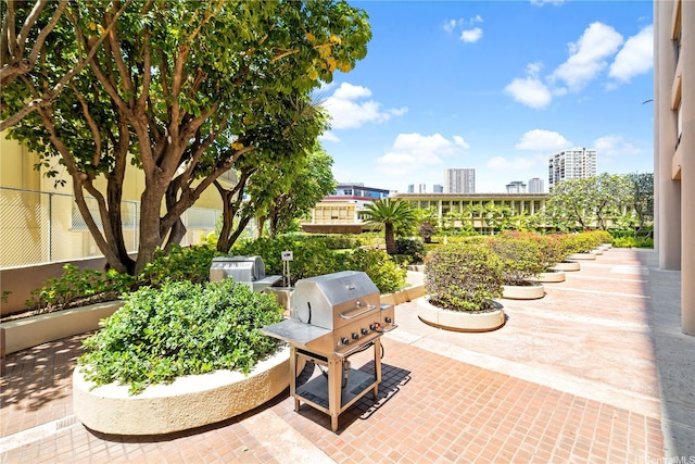 view of patio / terrace featuring fence and a city view