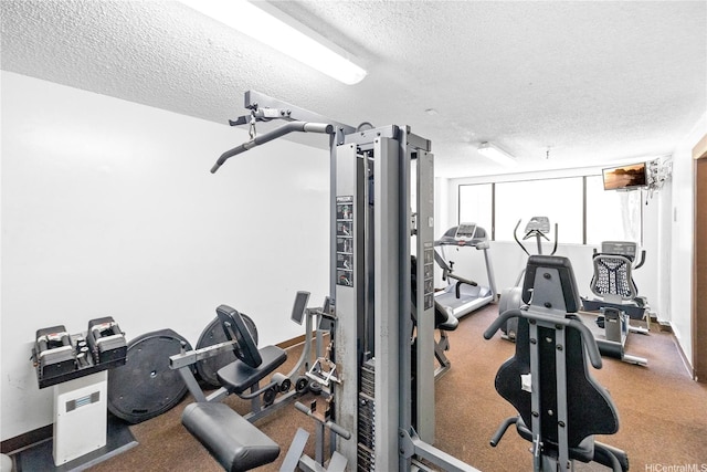 gym featuring a textured ceiling