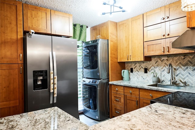 95-273 Waikalani Dr Unit D501, Mililani, HI 96789 - kitchen with stainless steel fridge with ice dispenser, stacked washer / drying machine, a sink, backsplash, and light stone counters