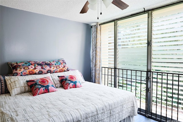 95-273 Waikalani Dr Unit D501, Mililani, HI 96789 - bedroom featuring a textured ceiling, access to outside, a wall of windows, and ceiling fan