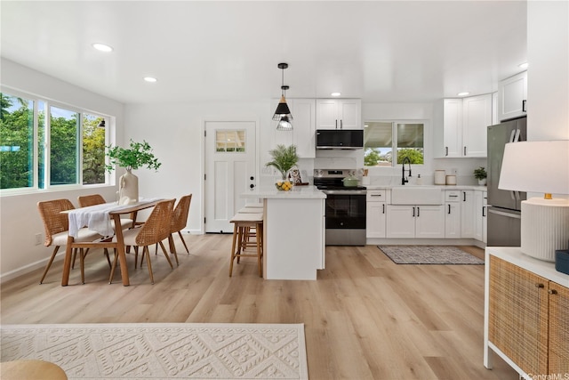 45-127 Waikapoki Rd Unit D, Kaneohe, HI 96744 - kitchen with appliances with stainless steel finishes, light wood-style floors, light countertops, white cabinets, and recessed lighting