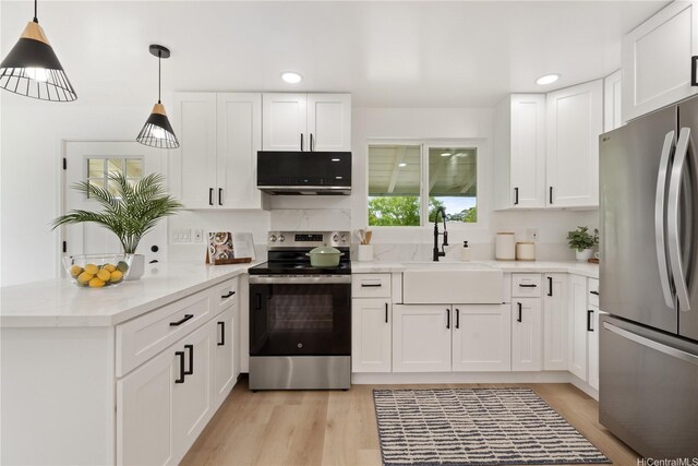 45-127 Waikapoki Rd Unit D, Kaneohe, HI 96744 - kitchen featuring appliances with stainless steel finishes, a sink, a peninsula, white cabinets, and recessed lighting