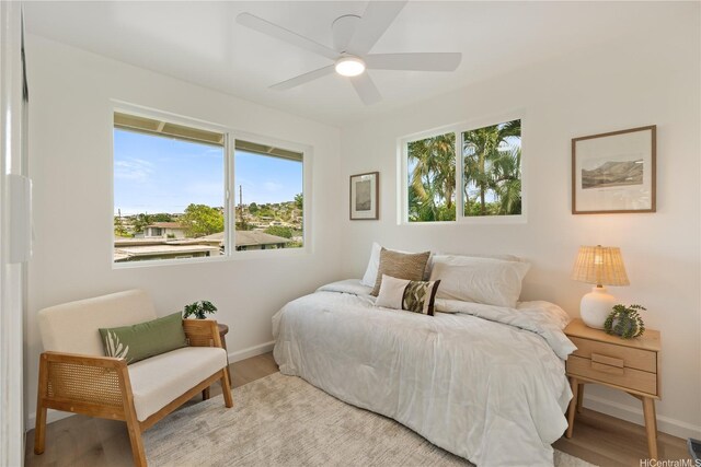 45-127 Waikapoki Rd Unit D, Kaneohe, HI 96744 - bedroom featuring wood finished floors, multiple windows, and baseboards