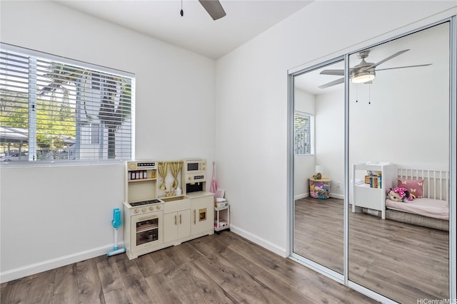 95-781 Wikao St Unit A101, Mililani, HI 96789 - playroom featuring ceiling fan, wood finished floors, and baseboards