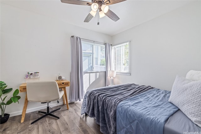 95-781 Wikao St Unit A101, Mililani, HI 96789 - bedroom featuring baseboards, wood finished floors, and a ceiling fan