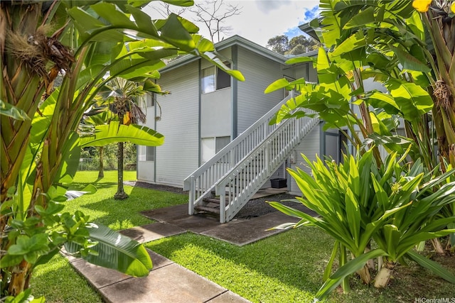 95-781 Wikao St Unit A101, Mililani, HI 96789 - view of home's exterior with a lawn, stairs, and central AC