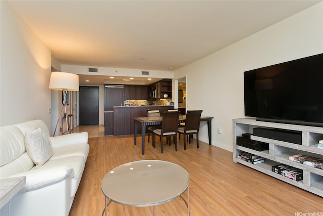 living area featuring visible vents and light wood-type flooring