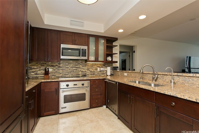 kitchen with a sink, decorative backsplash, open shelves, visible vents, and appliances with stainless steel finishes