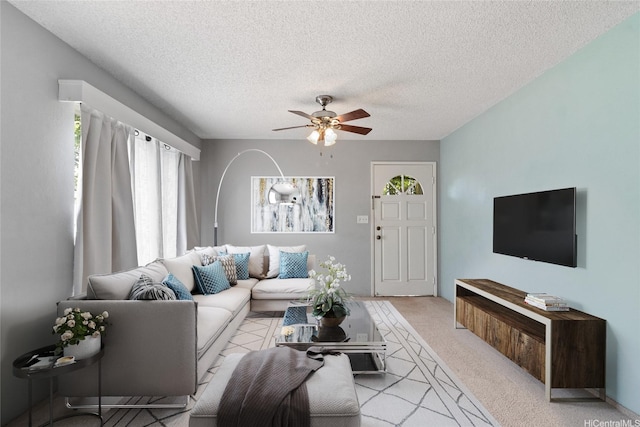 94-1449 Welina Loop Unit 3C, Waipahu, HI 96797 - living room with light colored carpet, a ceiling fan, and a textured ceiling
