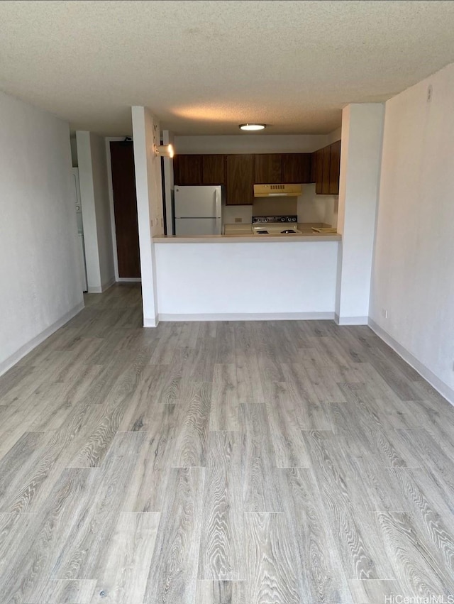 98-410 Koauka Loop Unit 4B, Aiea, HI 96701 - unfurnished living room featuring baseboards, light wood-type flooring, and a textured ceiling