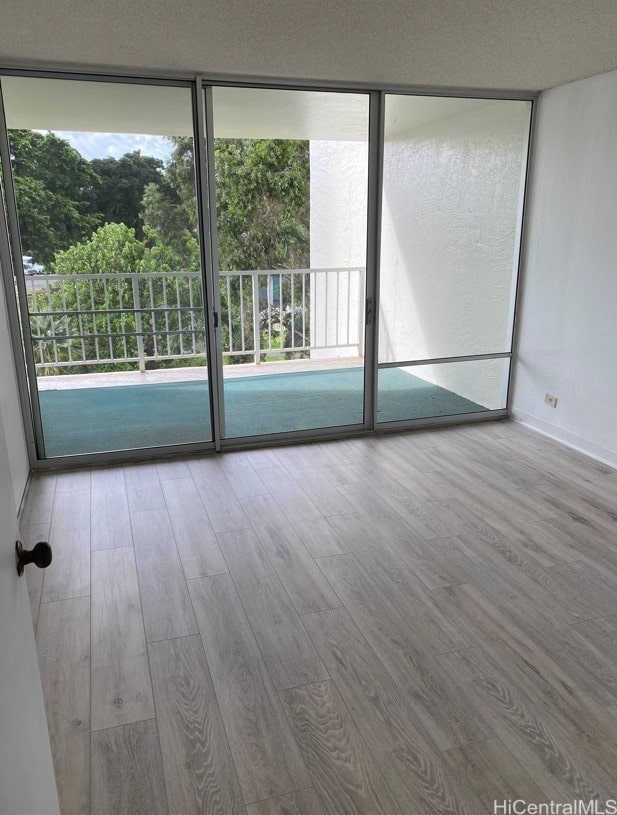 98-410 Koauka Loop Unit 4B, Aiea, HI 96701 - empty room with plenty of natural light and wood finished floors