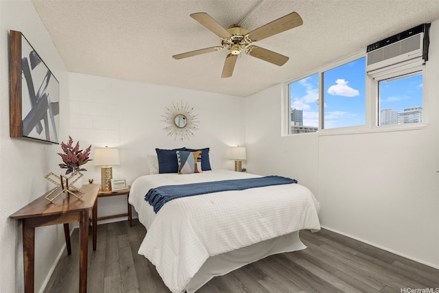 2211 Ala Wai Blvd Unit 2015, Honolulu, HI 96815 - bedroom with ceiling fan, a wall mounted air conditioner, a textured ceiling, baseboards, and wood finished floors