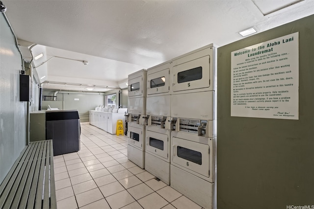 2211 Ala Wai Blvd Unit 2015, Honolulu, HI 96815 - kitchen featuring independent washer and dryer, stacked washer and dryer, and light tile patterned floors