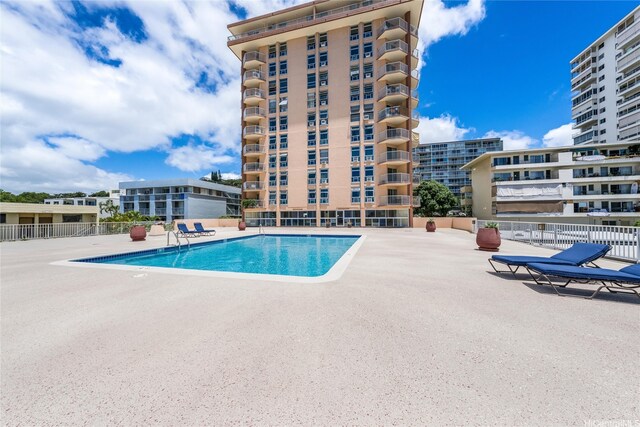 1031 Maunaihi Pl Unit 802, Honolulu, HI 96822 - community pool with a patio and fence