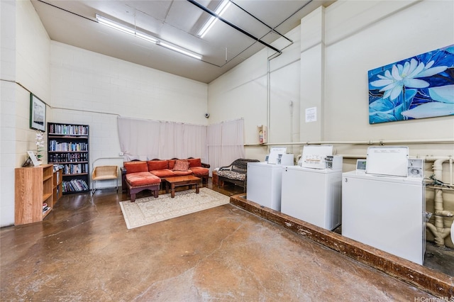 1031 Maunaihi Pl Unit 802, Honolulu, HI 96822 - communal laundry room with washing machine and clothes dryer and concrete block wall