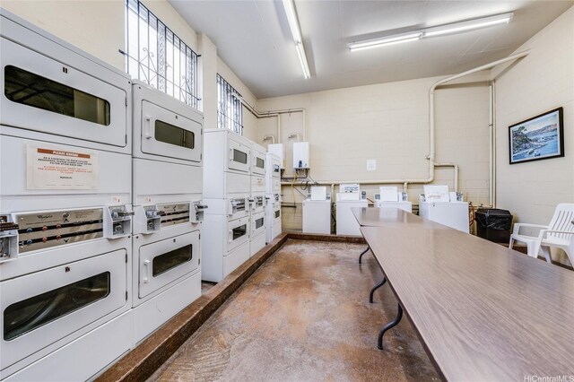 1031 Maunaihi Pl Unit 802, Honolulu, HI 96822 - shared laundry room featuring stacked washer and clothes dryer, concrete block wall, washer and dryer, and water heater