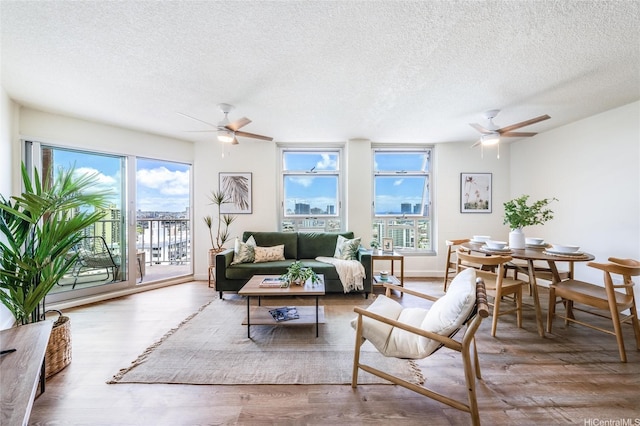 1031 Maunaihi Pl Unit 802, Honolulu, HI 96822 - living room featuring ceiling fan, a textured ceiling, healthy amount of natural light, and wood finished floors