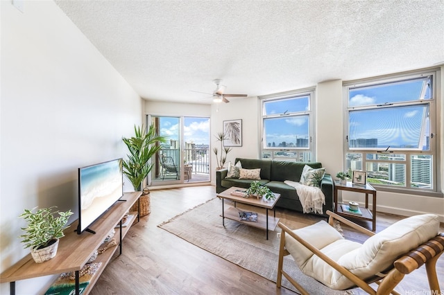 1031 Maunaihi Pl Unit 802, Honolulu, HI 96822 - living area featuring a textured ceiling, a ceiling fan, and wood finished floors