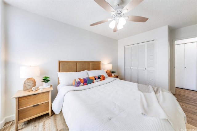 1031 Maunaihi Pl Unit 802, Honolulu, HI 96822 - bedroom with light wood-style floors and a ceiling fan