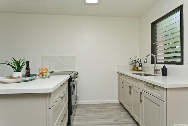 98-376 Kaonohi St Unit 3, Aiea, HI 96701 - kitchen featuring light wood-style floors, a sink, electric range, and light stone counters