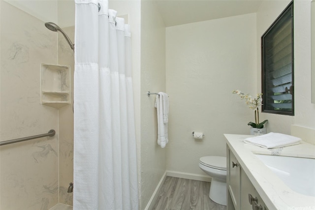 98-376 Kaonohi St Unit 3, Aiea, HI 96701 - bathroom with curtained shower, wood finished floors, baseboards, vanity, and toilet