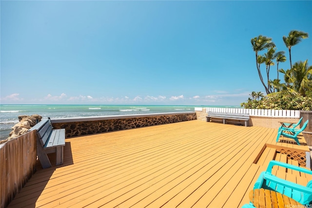 deck with a water view and a beach view