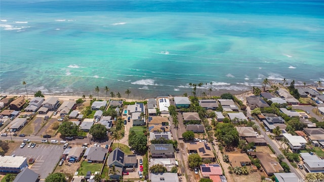 bird's eye view featuring a view of the beach, a residential view, and a water view