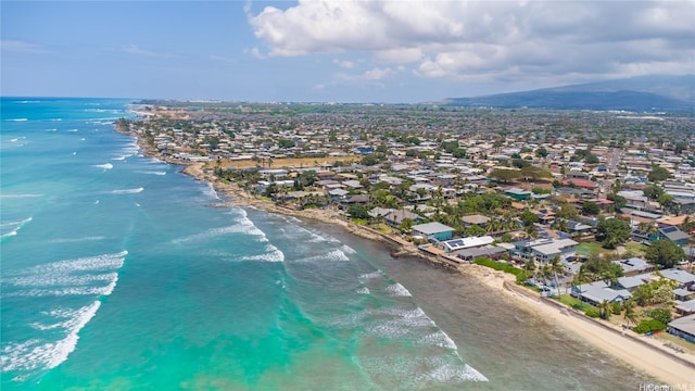 birds eye view of property with a water and mountain view, a view of the beach, and a residential view