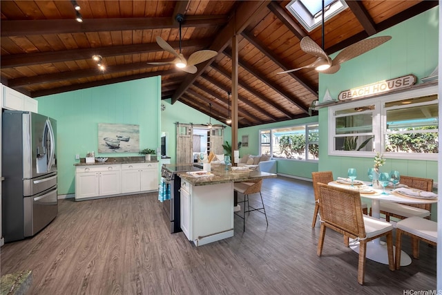 kitchen with a ceiling fan, wooden ceiling, dark wood-style floors, open floor plan, and stainless steel appliances