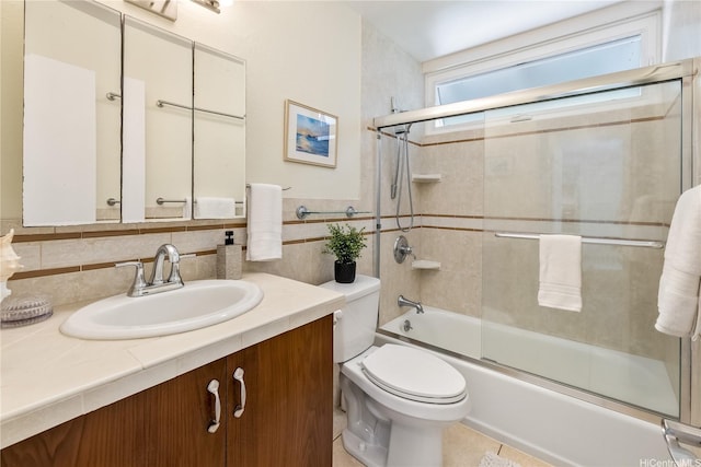 44-1303 Kou Pl Unit 1103, Kaneohe, HI 96744 - bathroom featuring vanity, toilet, enclosed tub / shower combo, tile walls, and backsplash