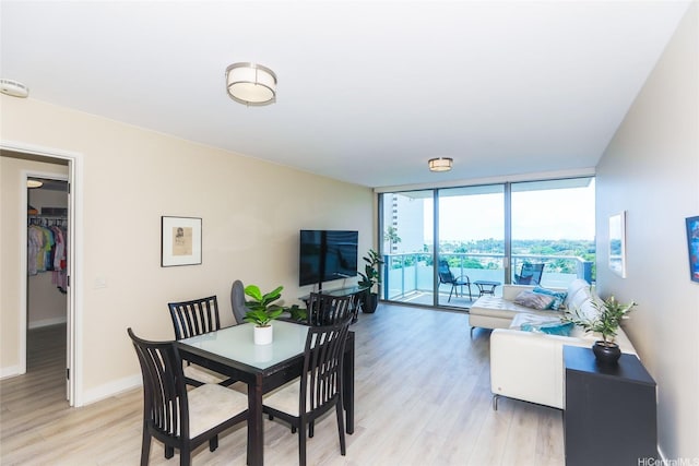 1551 Ala Wai Blvd Unit 703, Honolulu, HI 96815 - dining room with light wood-style floors, floor to ceiling windows, and baseboards