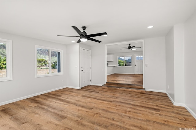 empty room featuring baseboards, a ceiling fan, wood finished floors, and recessed lighting