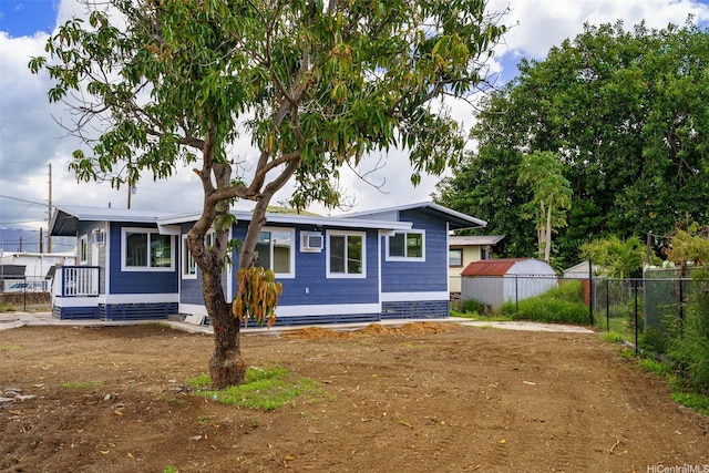 view of front of house featuring fence