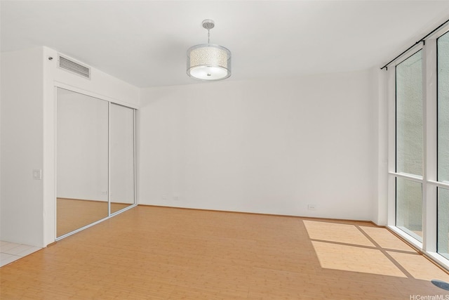 unfurnished bedroom with visible vents and a closet