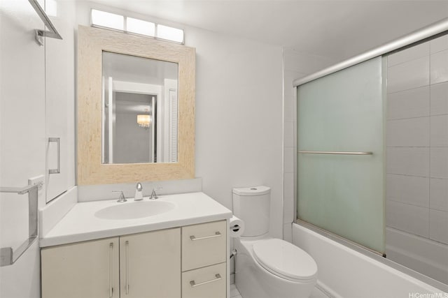bathroom with bath / shower combo with glass door, vanity, and toilet