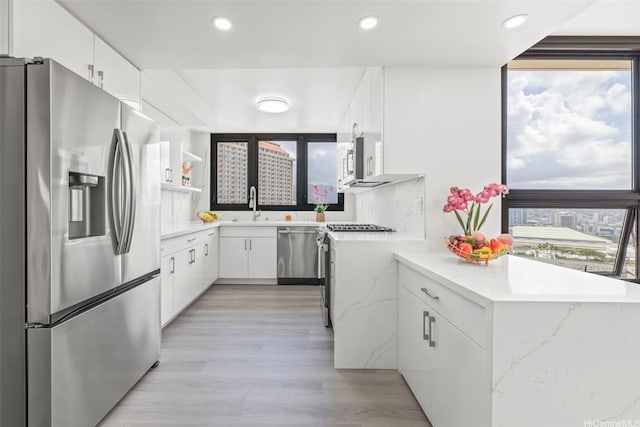 1600 Ala Moana Blvd Unit 2700, Honolulu, HI 96815 - kitchen with stainless steel appliances, white cabinetry, light wood-type flooring, recessed lighting, and light stone counters