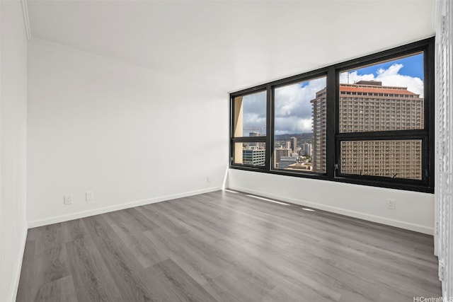 1600 Ala Moana Blvd Unit 2700, Honolulu, HI 96815 - empty room with wood finished floors, baseboards, plenty of natural light, and ornamental molding