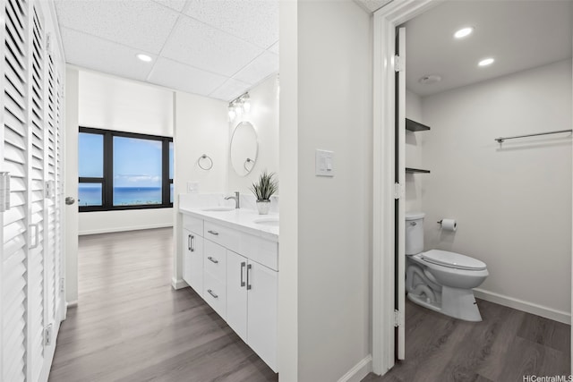 1600 Ala Moana Blvd Unit 2700, Honolulu, HI 96815 - full bathroom featuring wood finished floors, toilet, a drop ceiling, baseboards, and double vanity
