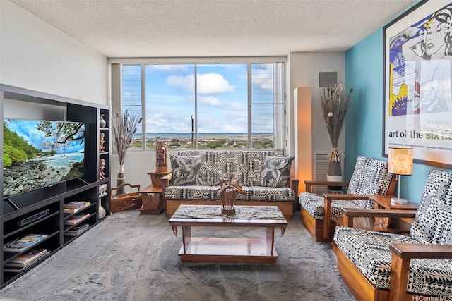 living area with visible vents and a textured ceiling