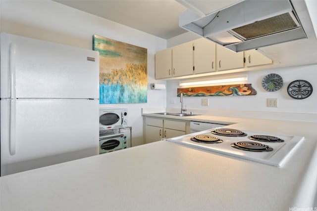 kitchen featuring washer / clothes dryer, range hood, a sink, light countertops, and white appliances