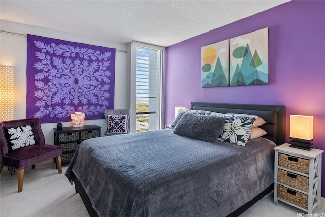 bedroom with carpet and a textured ceiling