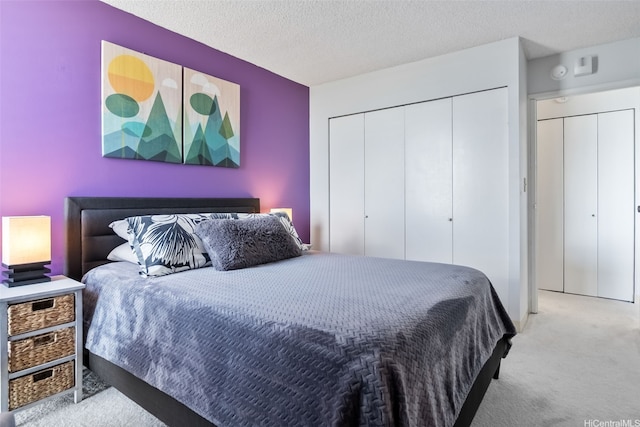 carpeted bedroom featuring a closet and a textured ceiling