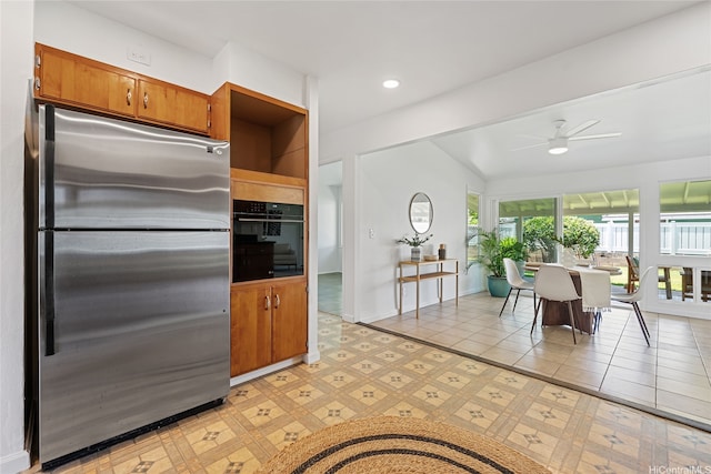 15 Aimikana St, Kailua, HI 96734 - kitchen with stainless steel fridge, black oven, brown cabinets, ceiling fan, and baseboards