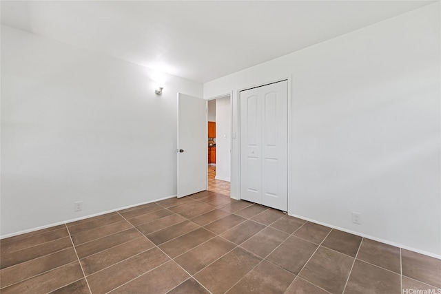 15 Aimikana St, Kailua, HI 96734 - spare room featuring dark tile patterned floors and baseboards